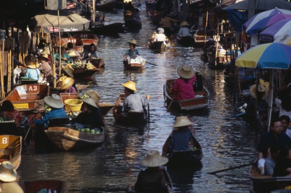 THAILAND, South, Bangkok, Damnoen Saduak Floating Market fruit vendors in their canoes on the main