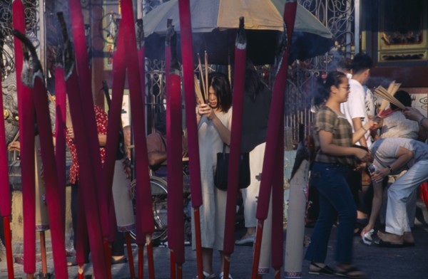 MALAYSIA, Penang, Georgetown, Kuan Yin Teng or Temple of Mercy with people carrying jos sticks and