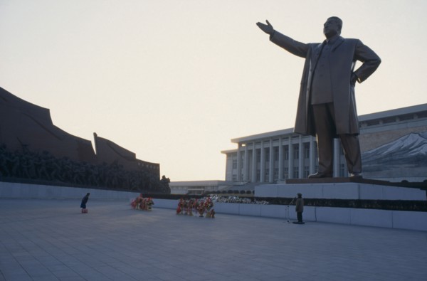 NORTH KOREA, Pyongyang, "Woman bowing in respect in front of statue of Kim II Sung, the Grand