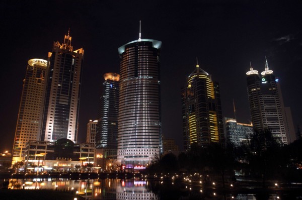 CHINA, Shanghai, Waterfront city skyline with skyscrapers illuminated at night