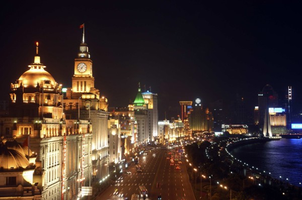 CHINA, Shanghai, Aerial view along the city waterfront illuminated at night
