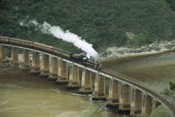 SOUTH AFRICA, Western Cape, Wilderness National Park, Tootsie steam train on bridge at Dolphin