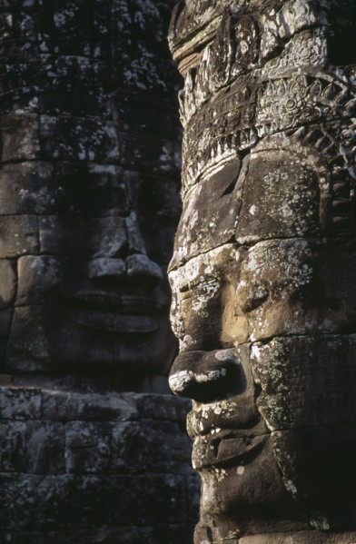 CAMBODIA, Siem Reap, Angkor Thom, Bayon Temple details of two of the four faced towers