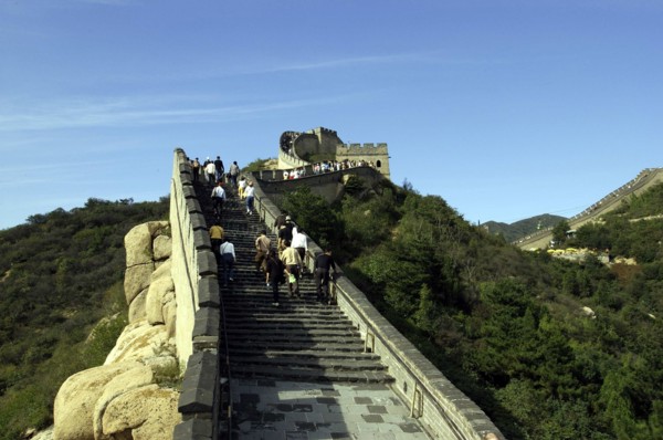 CHINA, Great Wall, View along a section of the wall with tourists walking up steps