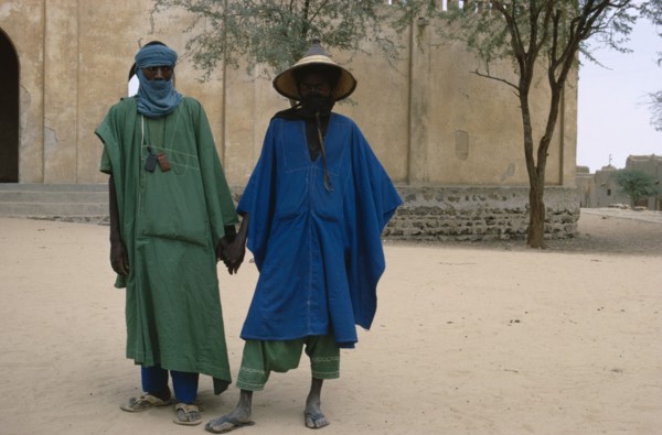 MALI, People, Two Touareg men in traditional dress holding hands.
