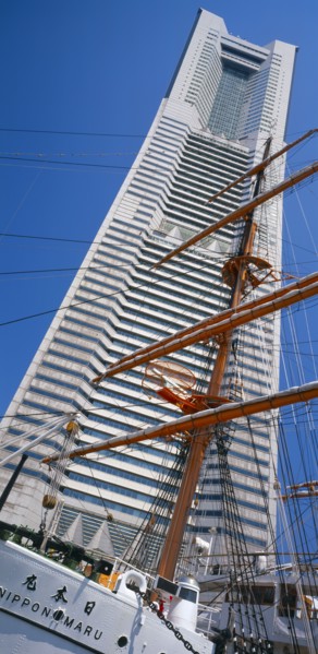 JAPAN, Honshu, Yokohama, View of the Nippon Maru tall ships mast with Landmark Tower skyscraper