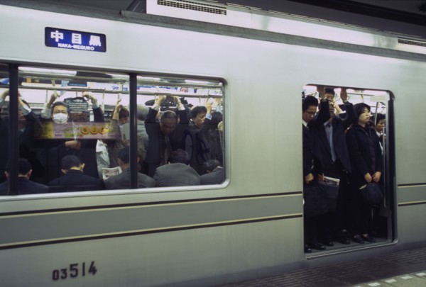 JAPAN, Honshu, Tokyo, Subway train at a platform with passengers crowded on