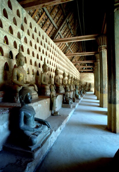 LAOS, Vientiane, View along row of seated Buddha statues at Wat Si Saket