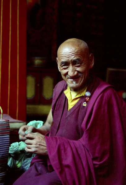 INDIA, Sikkim, Rumtek Gompa, Portrait of monk performing Pujar ceremony  and the making of a
