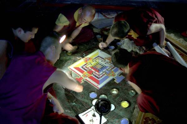 INDIA, Sikkim, Rumtek Gompa, Several monks painting decorative patterns for the Pujar ceremony  and