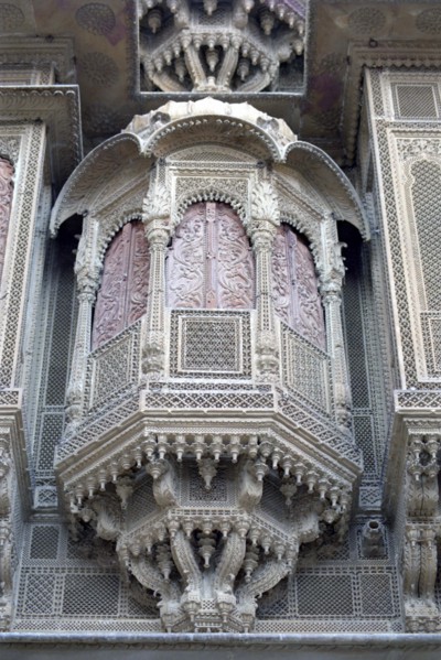 INDIA, Rajasthan, Jaisalmer, Detail of elaborate hand carved window frame of the Patwon Ki Haveli