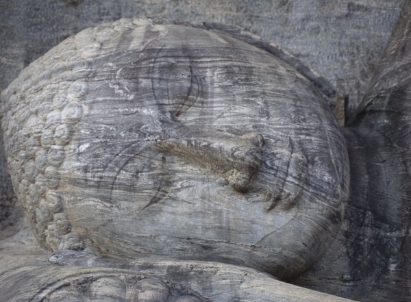 SRI LANKA, Polonnaruwa, Gal Vihara.  Mid twelth century reclining Buddha figure shown at the moment