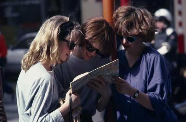 BELGIUM, Brussels, Three female tourists reading a map outside the Grand Palace