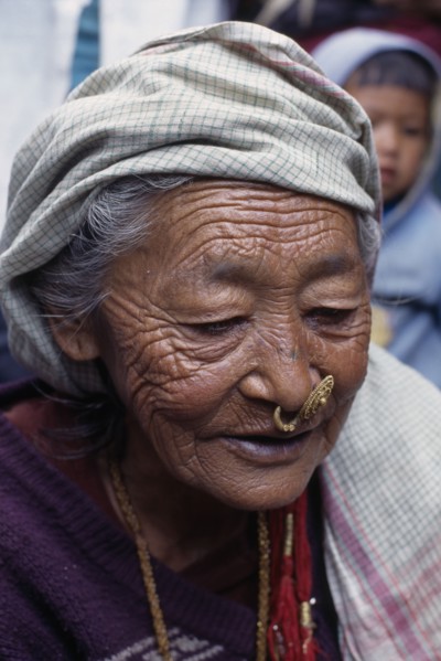 NEPAL, East, Dhankuta Region, Elderly Limbuni tribeswoman wearing traditional gold Limbu nose