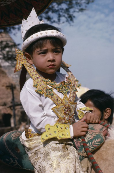 MYANMAR, Children, Very young boy at novice monk initiation ceremony.