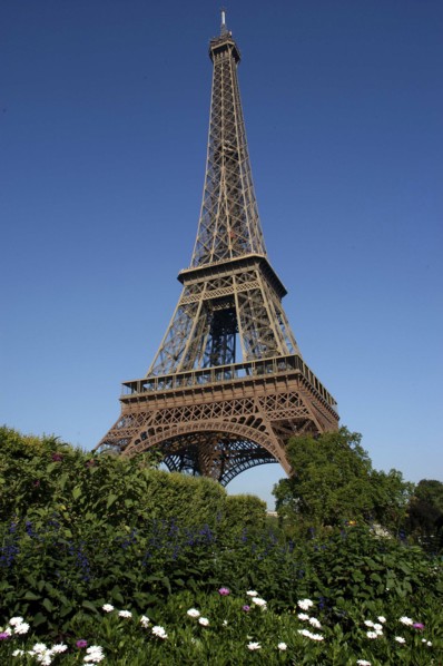 FRANCE, Ile de France, Paris, Angled view of The Eiffel Tower against a blue sky