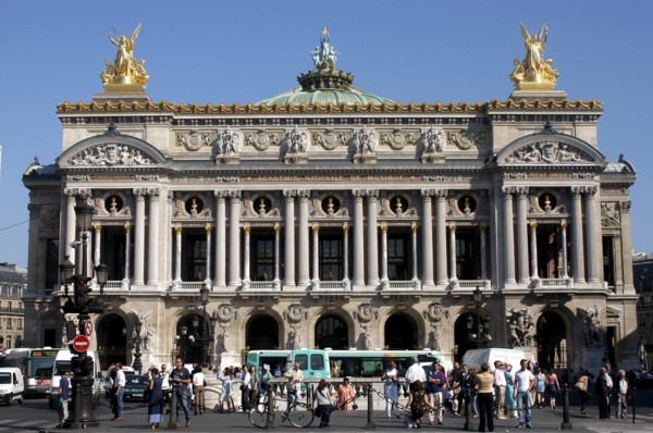 FRANCE, Ile de France, Paris, The Opera Garnier columned facade with golden statues a top and crowd