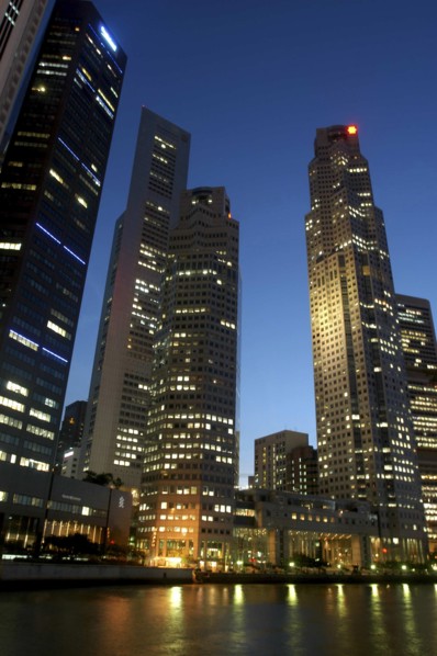 SINGAPORE, Raffles City, City skyline illuminated at dusk