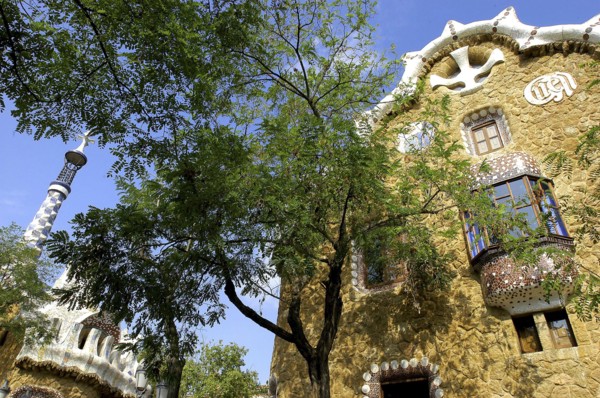 SPAIN, Catalonia, Barcelona, Gaudi architecture seen through trees in Parc Guell