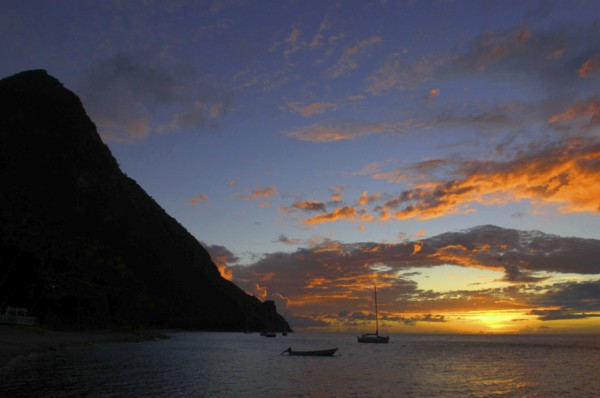WEST INDIES, St Lucia, Sunset over the sea with passing boats seen from Jalousie Beach
