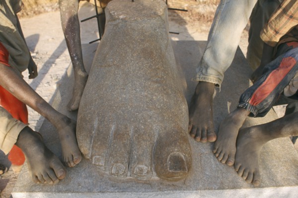 BURKINA FASO, Ougadougou, Boys playing in Managa Sculpture park on the outskirts of Ouga.  Cropped