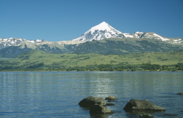 ARGENTINA, Neuquen, Lanin National Park, View over bolders of Huechulafquen Lake toward snow capped