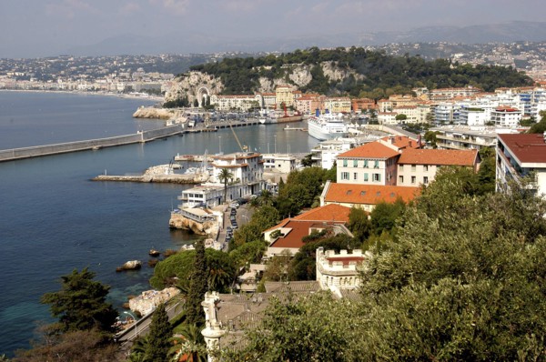 FRANCE, Cote d Azur, Nice, View over rooftops and harbour with the coastline beyond