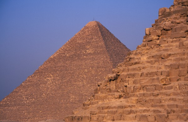 EGYPT, Cairo Area, Giza, Section of pyramids against a blue sky