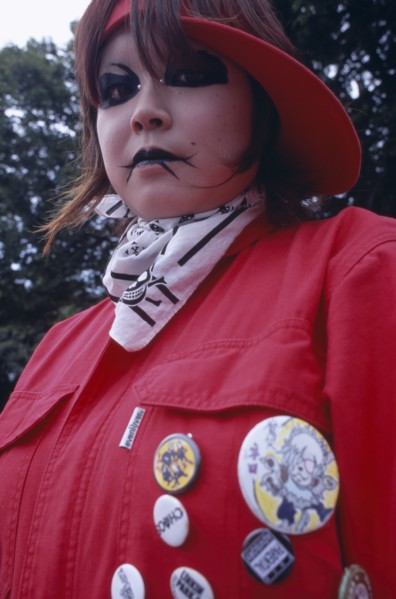 JAPAN, Honshu, Tokyo, Harajuku District. Portrait of young teenage girl wearing a red jacket and