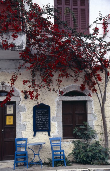 GREECE, Peloponnese, Mani Peninsula, Kardamili. Taverna exterior with blue table and chairs on