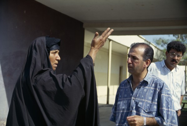 IRAQ, Amara, Marsh Arab woman talking and demonstrating with a hand gesture to a Oxfam engineer.