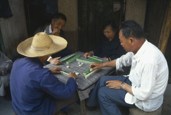 CHINA, Yunnan Province, Kunming, Playing game of majong.