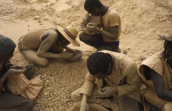 BURKINA FASO, Sahel, Dust covered group of gold miners.