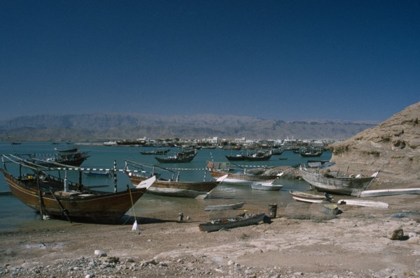 OMAN, Sur, Boats moored along coastline.