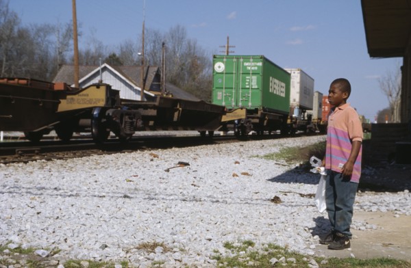 USA, Georgia, Madison, Child watching passing freight train.