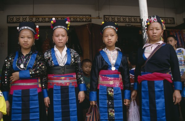 LAOS, Luang Prabang, Four Hmong girls in traditional dress.