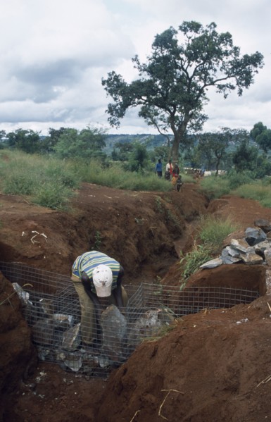 TANZANIA, West, Great Lakes Region, Refugees making gambions from stone filled wire cages to