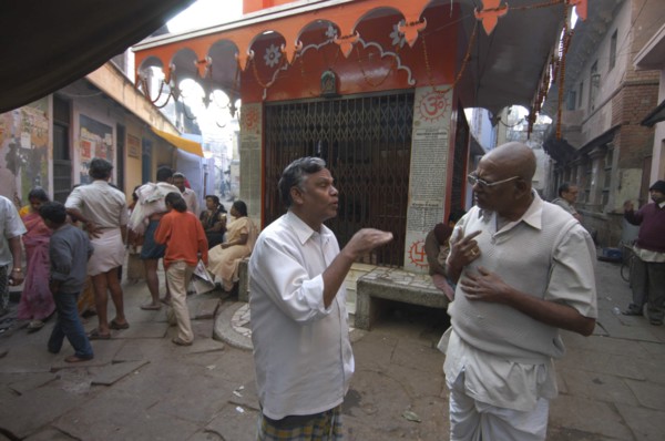 INDIA, Uttar Pradesh, Varanasi , Bengali Tole. Two middle aged men have a morning coversation