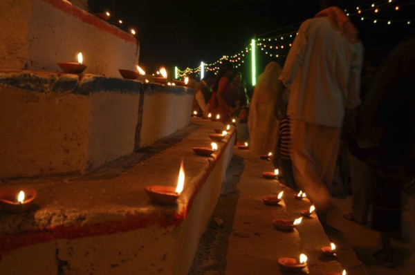 INDIA, Uttar Pradesh, Varanasi, Deep Diwali Festival. Oil lamps and crowds line the steps of the