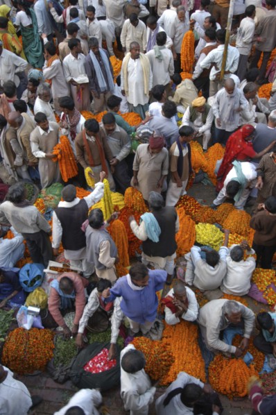 INDIA, Uttar Pradesh, Varanasi, View looking down on busy flower market with a majority of male