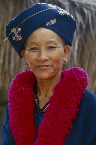 THAILAND, Chiang Rai, Mae Chan District. Portrait of a Iu Mien woman in traditional attire at her