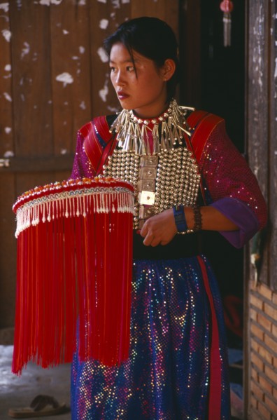 THAILAND, Chiang Rai Province, Doi Lan, Young Lisu woman in her New Year finery prior to going to a