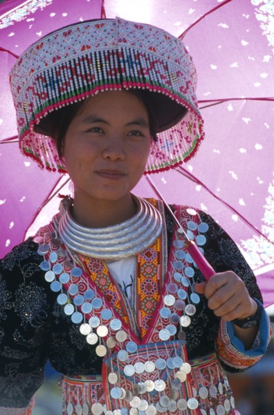 THAILAND, Chiang Mai, Hmong New Year. Young white Hmong woman in her New Year finery