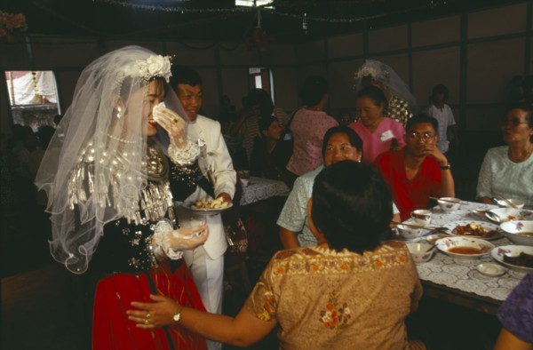 MYANMAR, Kachin State, Myitkyina, Jinghpaw wedding reception with Bridal couple and guests at the