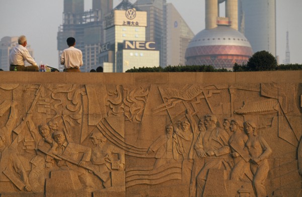 CHINA, Shanghai, The Martyr’s Monument.  Detail of relief carving with two men sitting on top of