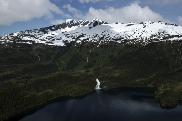 USA, Alaska, Prince William Sound, Aerial view over water and tree covered slopes leading toward