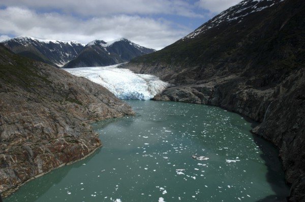 USA, Alaska, Tracy Arm Fjord, View along waterway toward icy slope and mountain peaks beyond