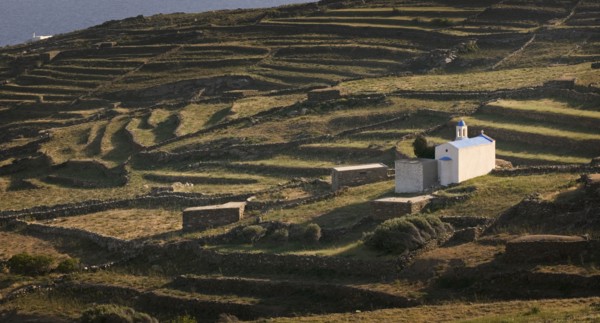 GREECE, Cyclades, Tinos, Religious shrine on a terraced hill side.