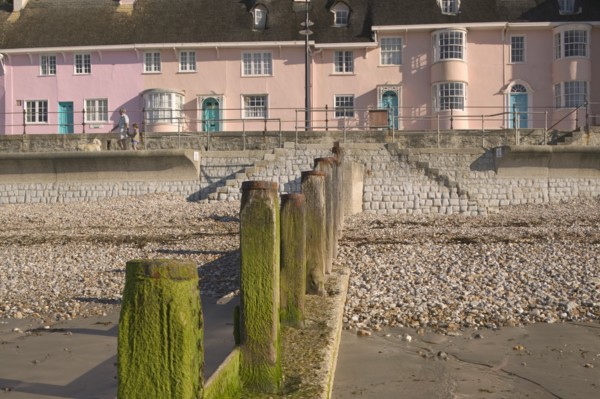 ENGLAND, Dorset, Lyme Regis, View of old fishermens cottages along the waterfront from the beach