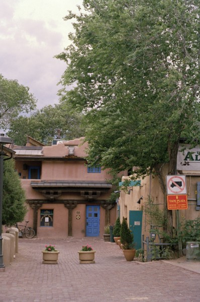 USA, Colorado, Taos Town, Street with flower tubs and traditional architecture